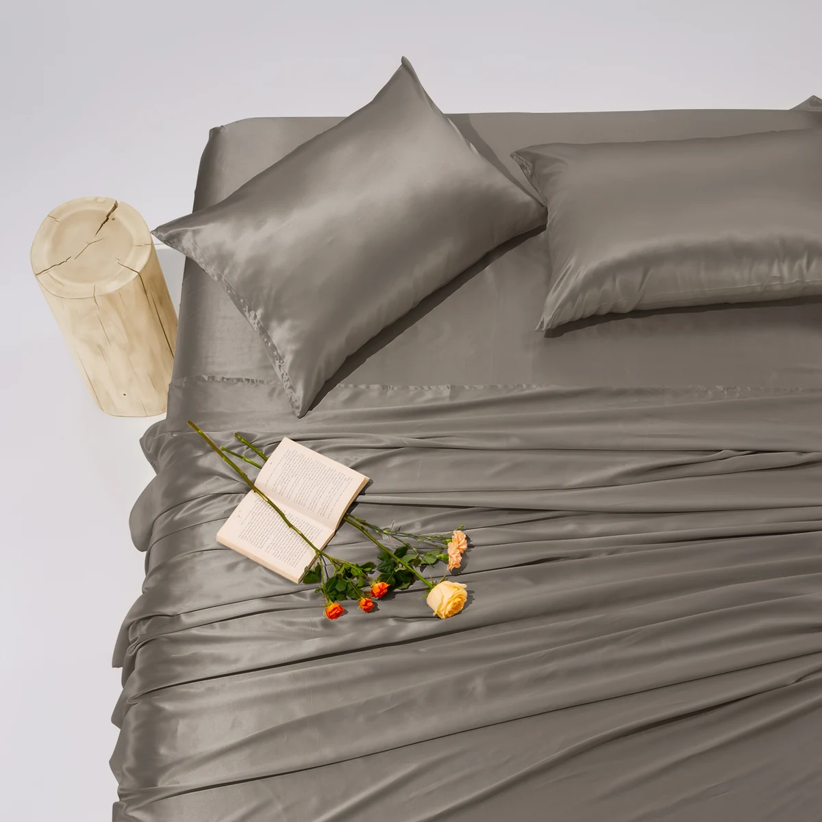 Promeed graphite silk sheets and pillows arranged on a bed